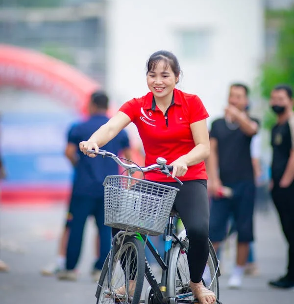 A girl on red riding a bicycle